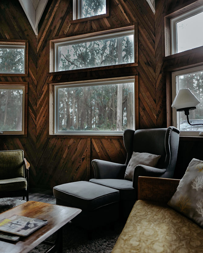 Sitting room with weathered, wood clad walls