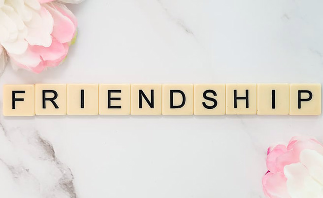 Wooden pieces spelling out 'Friendship'