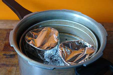 tin foil covered heart-shaped ramekins in a pressure cooker