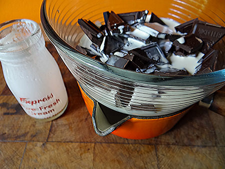 Melting dark chocolate with double cream to make a ganache