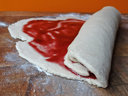 Rolling up jam roly poly