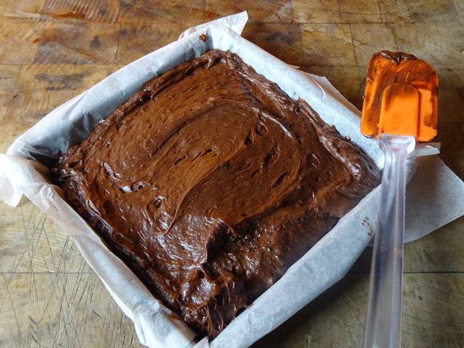 Putting the ganache layer on marzipan chocolate brownies | H is for Home