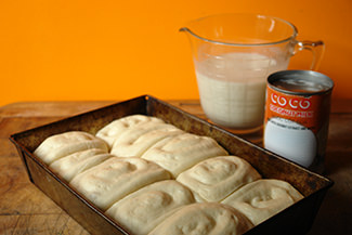 Risen panipopo dough in a rectangular baking tin | H is for Home