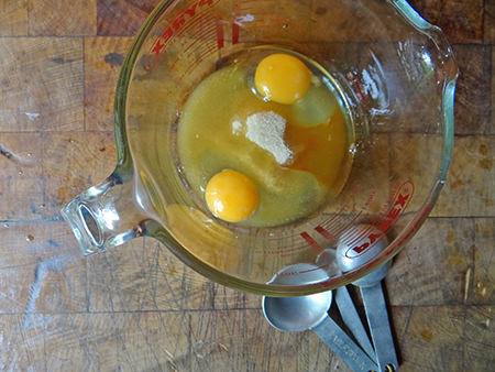 Eggs, sugar and vanilla essence in a large measuring jug