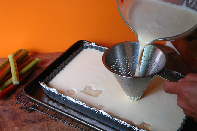Pouring custard on tart pastry base