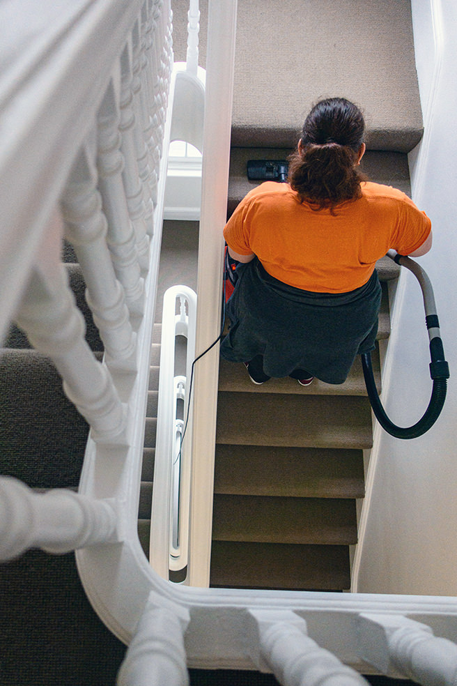 Woman vacuuming stairs