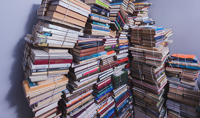 Large piles of books held together with string