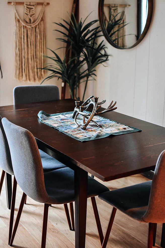 Wall mirror above a dining table & chairs