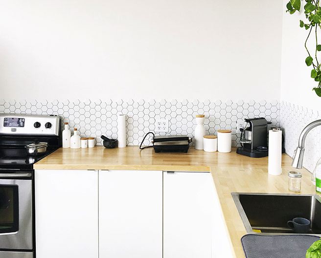 Kitchen with white cabinets and wood worktops