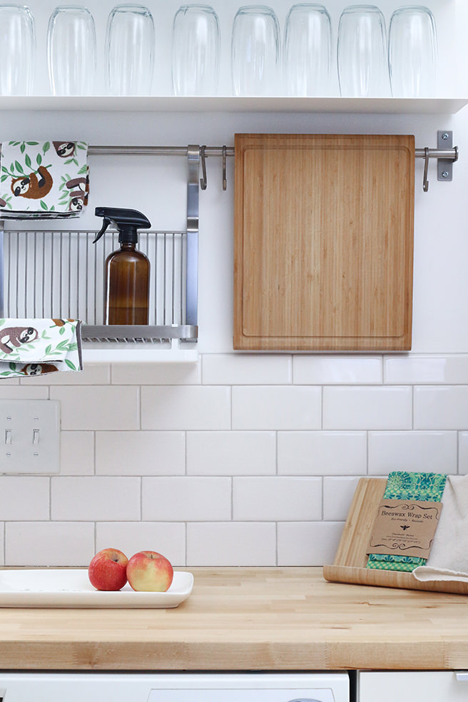 Kitchen with wooden worktops and white tiling