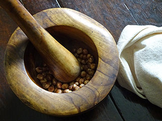 Grinding hazelnuts using a pestle & mortar