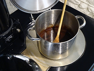 Heating cocoa, sugar and milk in a saucepan