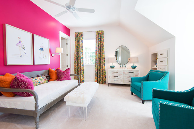 Sitting room decorated in hibiscus pink and white with turquoise upholstered armchairs