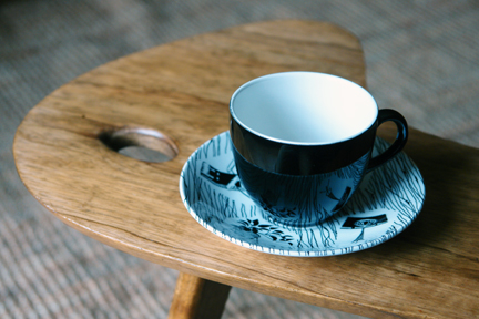 detail of vintage 1950s palette topped teak table with splayed legs with Ridgeway Homemaker tea cup & saucer