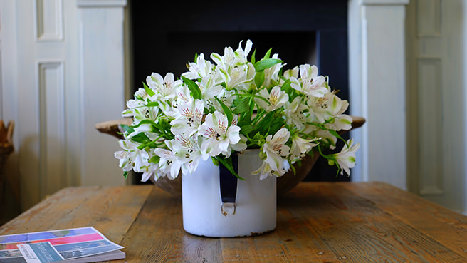 Jug of flowers on a table
