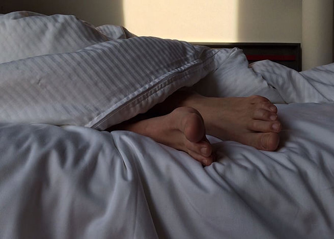 Feet of a person asleep in bed
