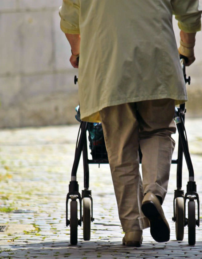 Old person with a walking frame