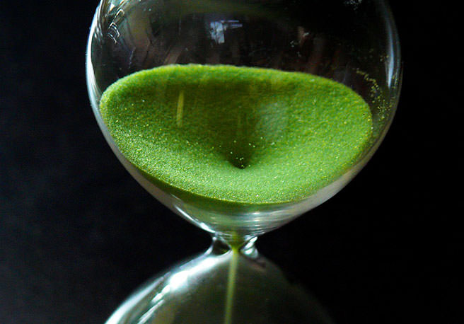 Hourglass with green sand Hourglass with green sand