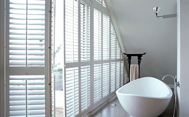 Plantation shutters in a white bathroom Plantation shutters in a white bathroom
