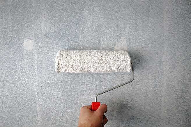 Painting a wall with a roller