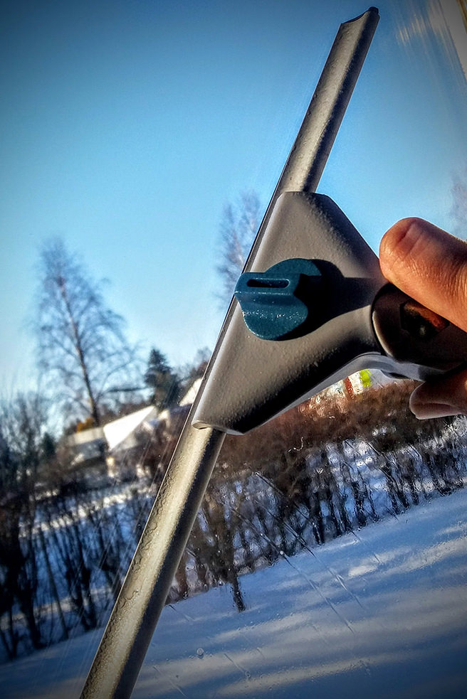 Cleaning a window with a squeegie